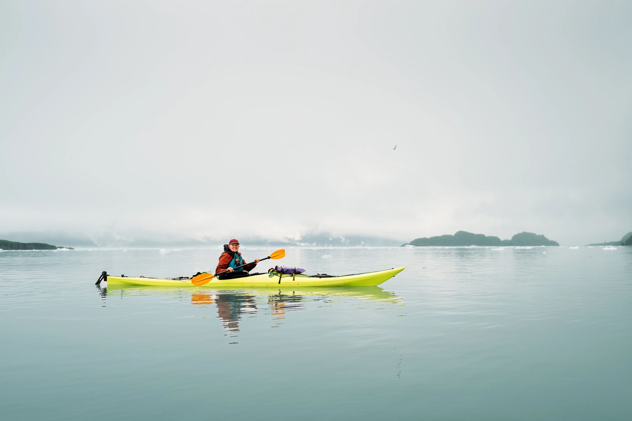 Kayaker on calm water representing kayaking rentals and tours