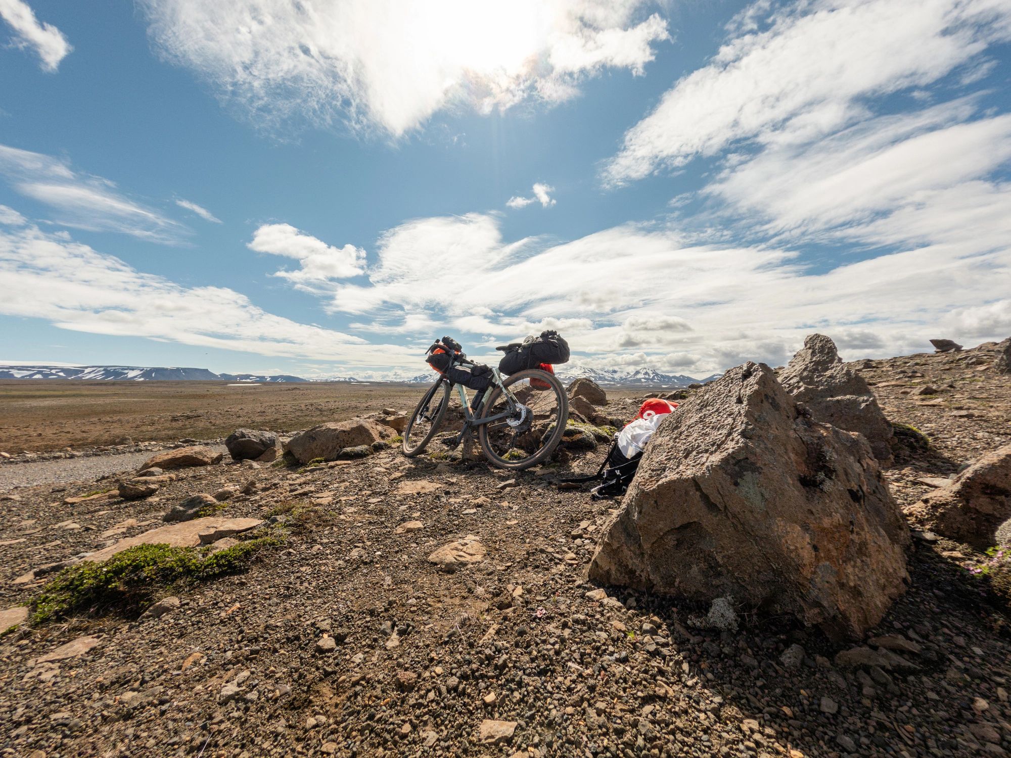 Bike on rocky terrain with mountains in the distance